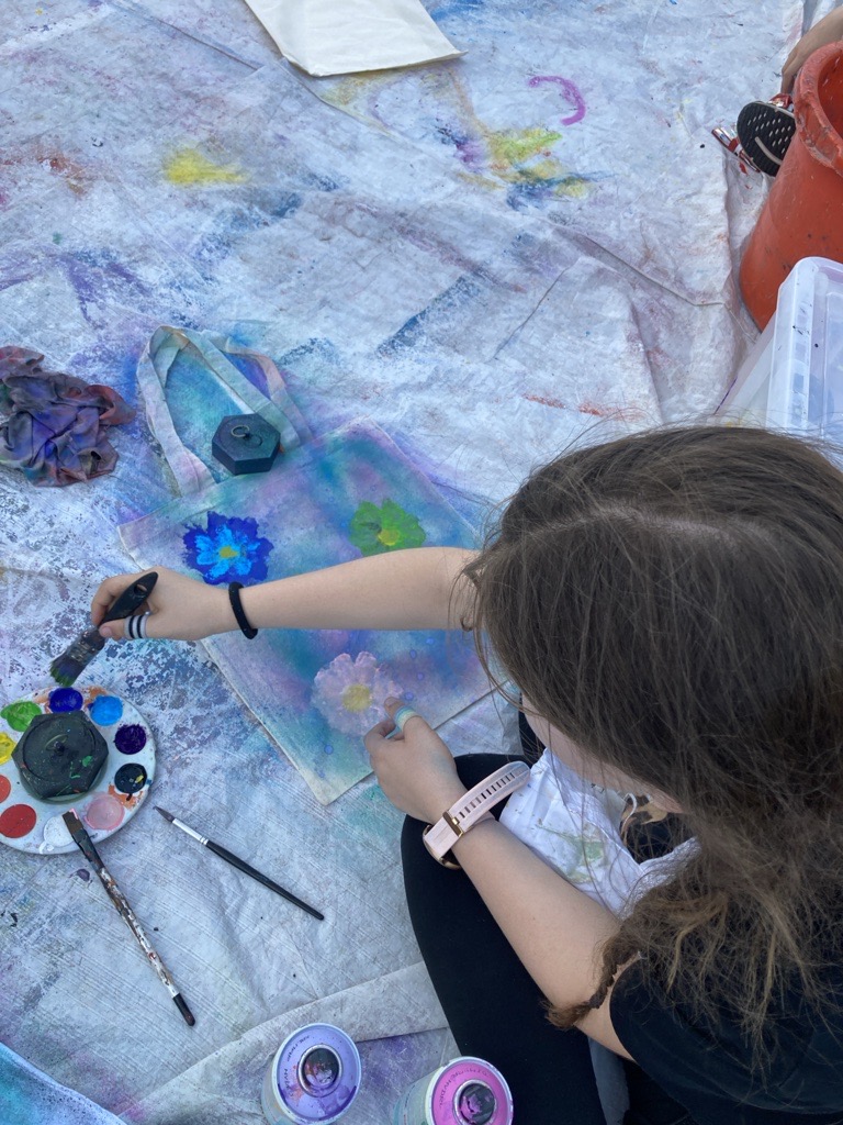 mad about art event girl painting flowers on fabric