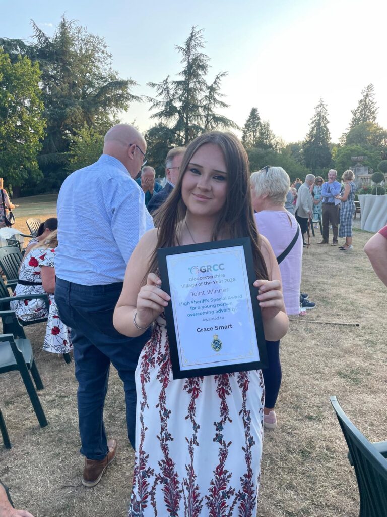 girl holding a grcc award